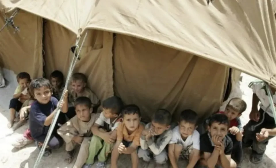 Children sitting together at a temporary shelter